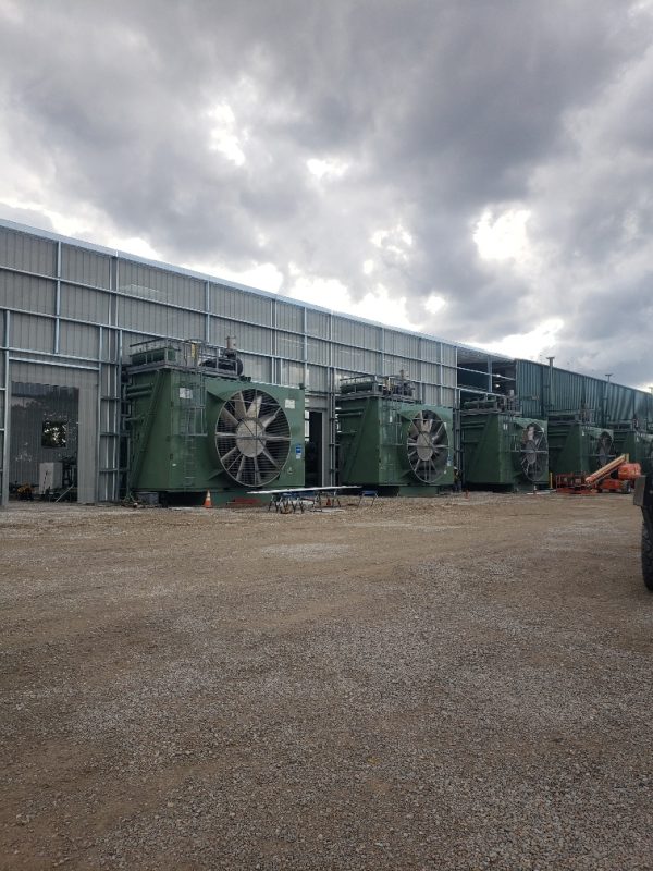 View of metal building with exhaust fans